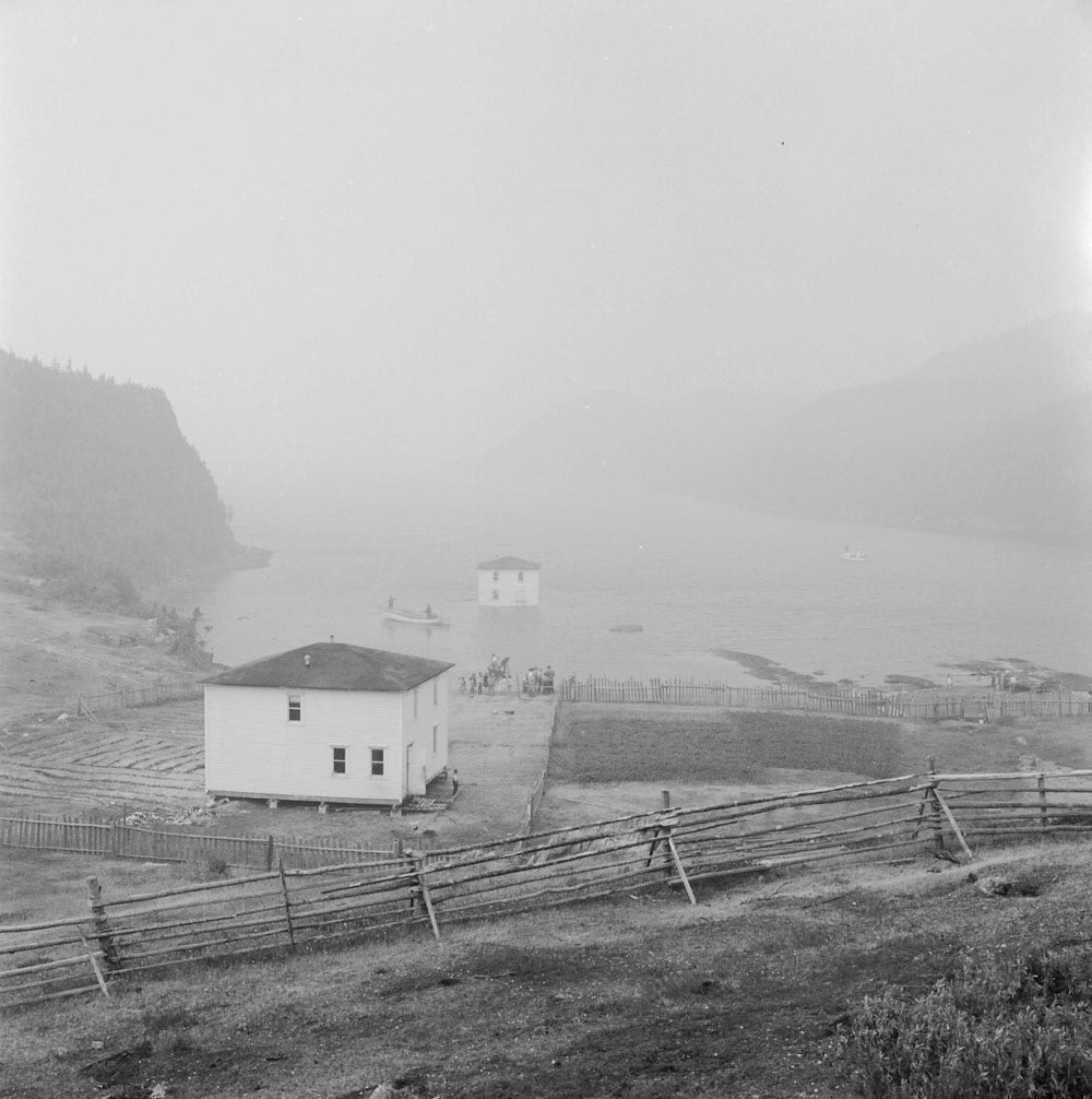 Fig. 102. Brooks, B. “A house being moved by floating it from Silver Fox Island, Bonavista Bay, to Dover, Newfoundland.” Library and Archive Canada, 4301898,…