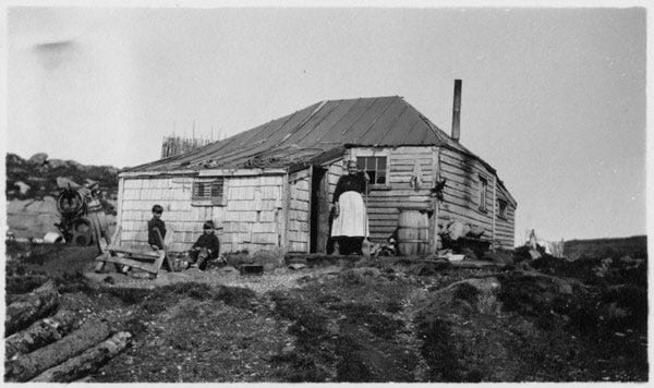 Fig. 78. Sears, Fred Coleman. “Woman and Two Young Boys in Front of Clapboard House.” The Rooms Archive, A 58–109, International Grenfell Association Photogr…