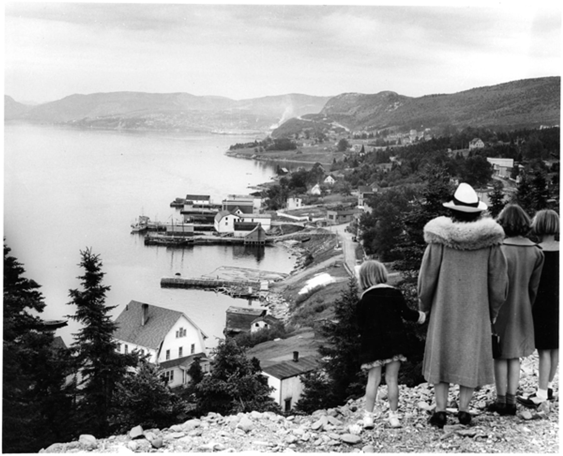 Anderson, Gustav. “Woman and Three Young Girls on Hill Overlooking Curling.” The Rooms Archive, VA 14–80, Newfoundland Tourist Development Board Photograph C…